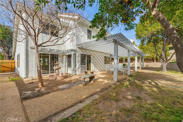 rear view of property featuring a patio and a pergola