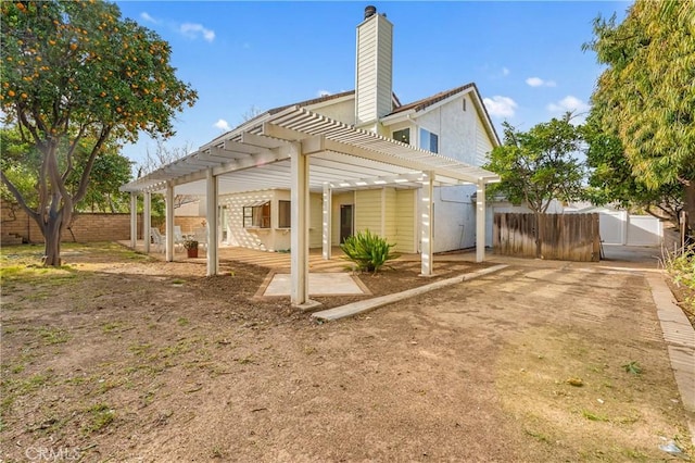 back of house featuring a pergola