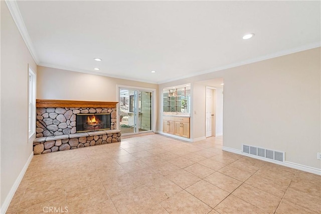 unfurnished living room featuring a fireplace, light tile patterned flooring, and ornamental molding