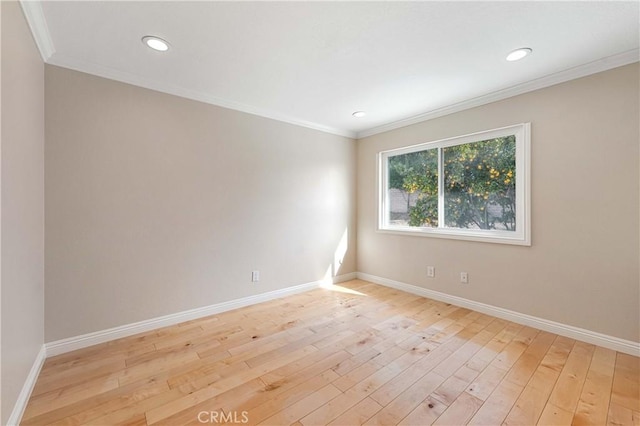 unfurnished room featuring light hardwood / wood-style floors and crown molding