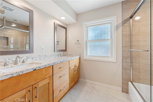 bathroom featuring vanity and bath / shower combo with glass door