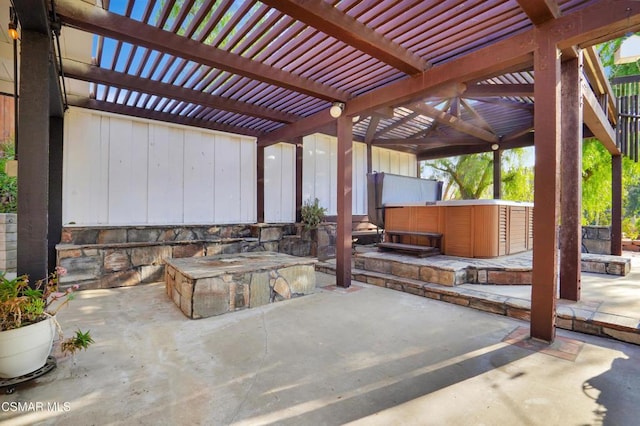 view of patio with a hot tub and a pergola