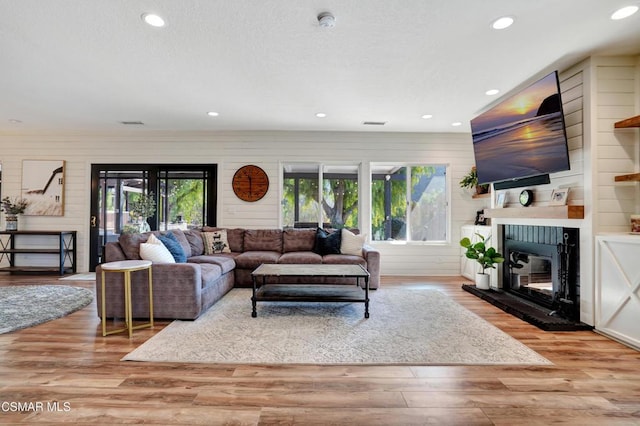 living room featuring wood-type flooring and wooden walls