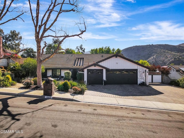 view of front of home with a garage and a mountain view