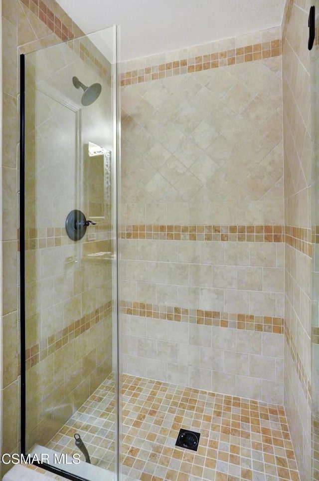 bathroom featuring a shower with door