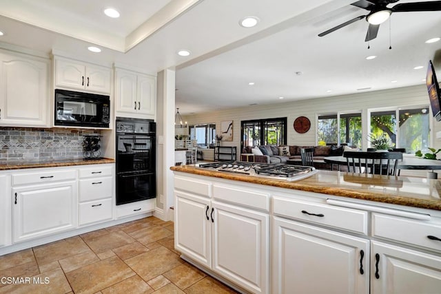 kitchen featuring black appliances, backsplash, stone counters, and white cabinetry