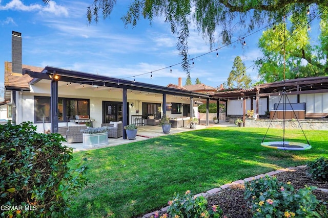 back of house with a lawn, an outdoor hangout area, and a patio