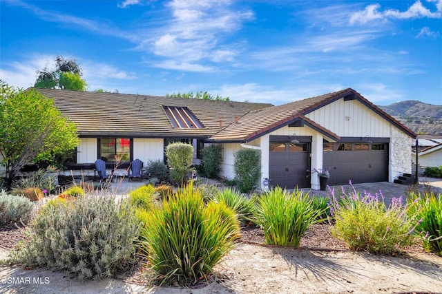 view of front of home with a garage and a mountain view