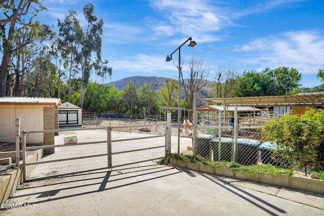 view of patio / terrace with a mountain view and an outdoor structure