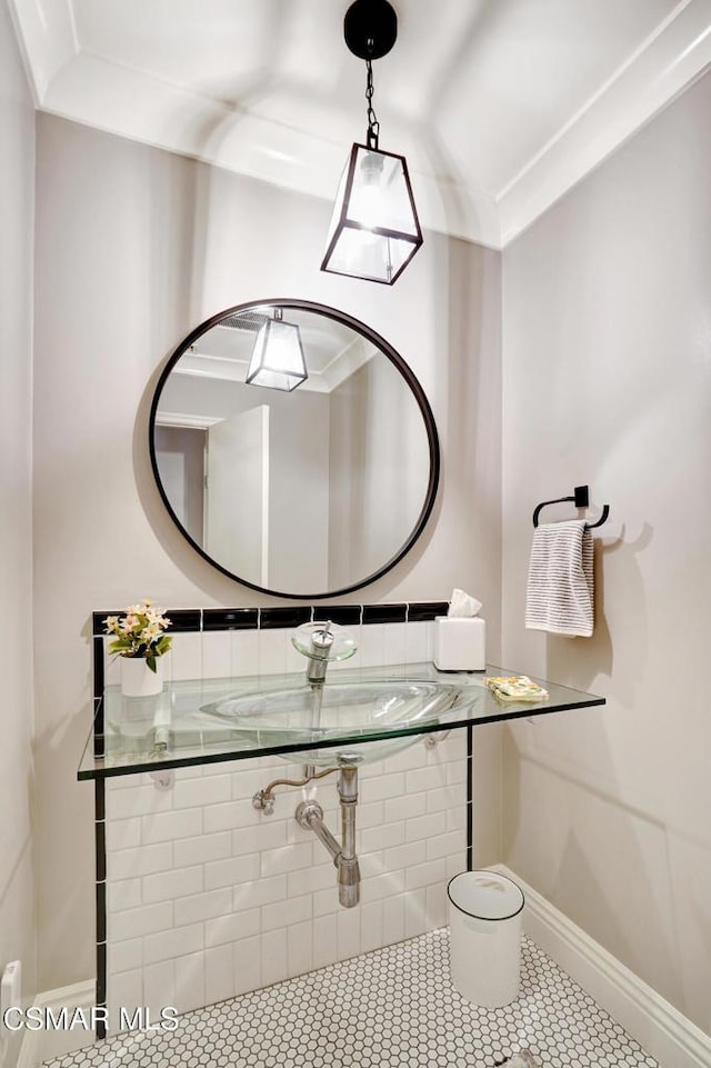 bathroom with tile patterned floors, sink, and ornamental molding