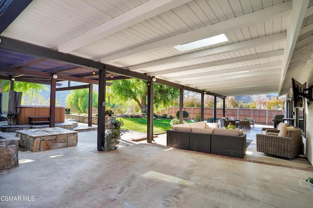 view of patio / terrace with a hot tub and an outdoor hangout area