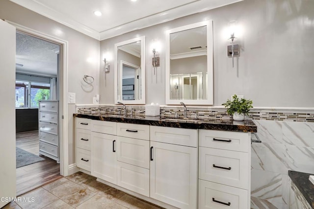 bathroom with tile patterned floors, vanity, and ornamental molding