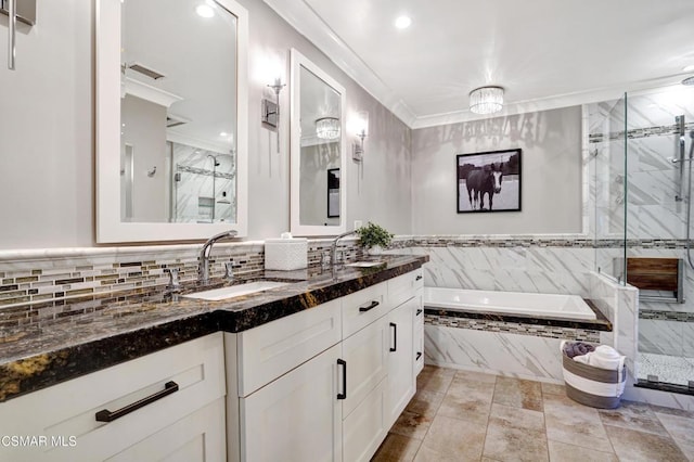 bathroom with vanity, ornamental molding, and shower with separate bathtub