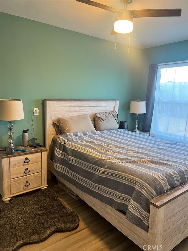 bedroom featuring ceiling fan and hardwood / wood-style floors