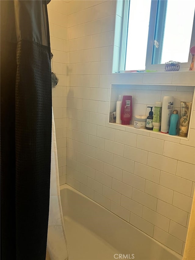 bathroom with shower / tub combo with curtain