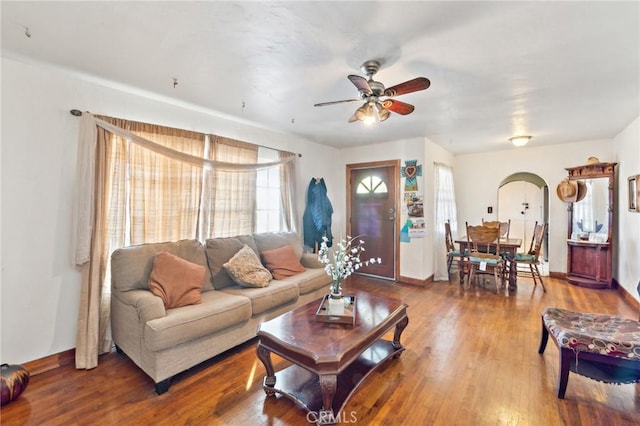 living room featuring ceiling fan and hardwood / wood-style floors