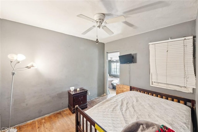 bedroom with light wood-type flooring and ceiling fan