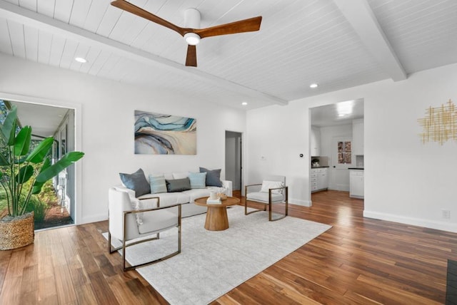 living room featuring ceiling fan, dark hardwood / wood-style flooring, and beam ceiling