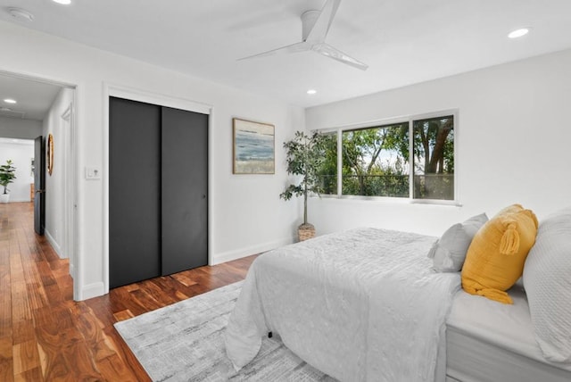 bedroom with ceiling fan and dark wood-type flooring