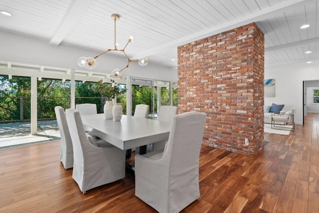 dining area featuring a wealth of natural light, dark hardwood / wood-style flooring, beam ceiling, and an inviting chandelier