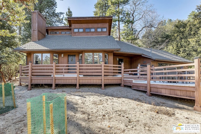 rear view of property with a wooden deck