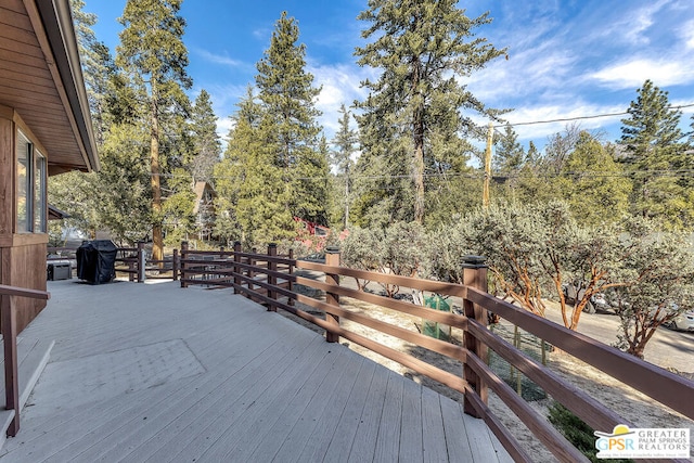 wooden deck featuring area for grilling