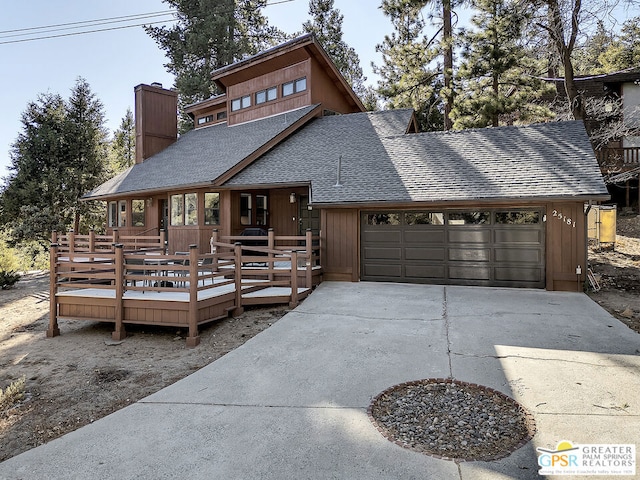 view of front of house featuring a garage and a wooden deck