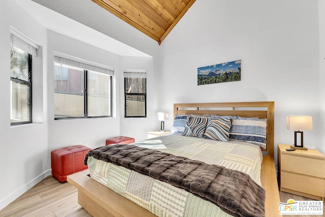 bedroom with light hardwood / wood-style flooring, wood ceiling, and vaulted ceiling