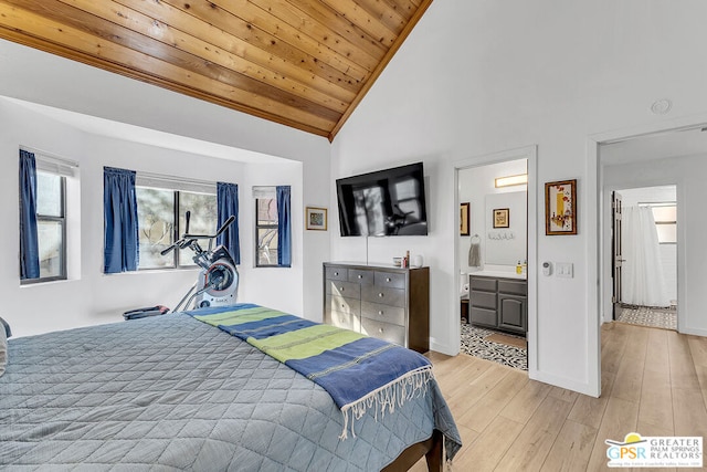 bedroom with ensuite bathroom, vaulted ceiling, light wood-type flooring, and wooden ceiling