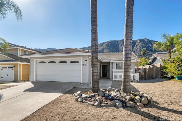 view of front of property featuring a garage and a mountain view