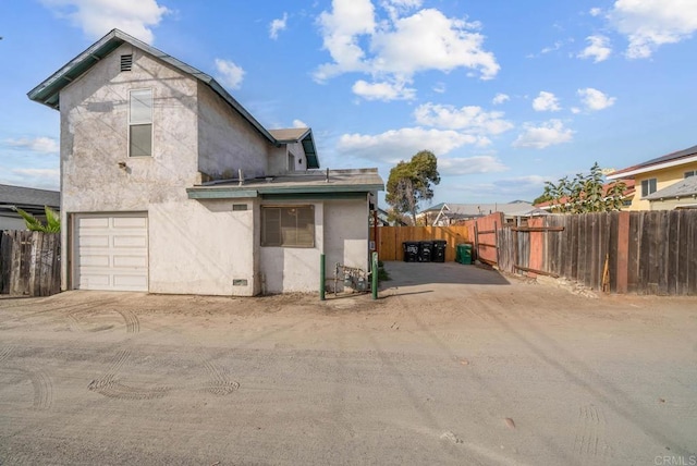 back of house featuring a garage