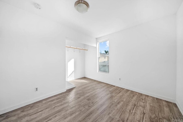 spare room featuring a barn door and hardwood / wood-style floors