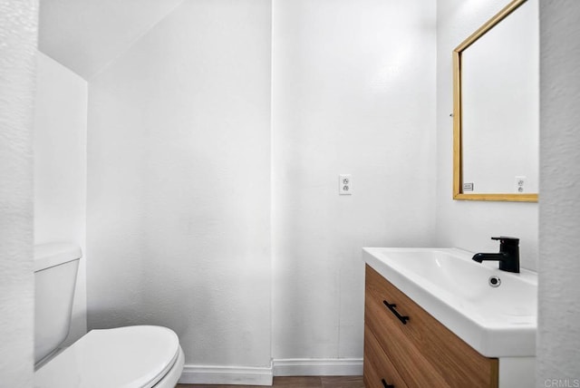 bathroom with toilet and vanity