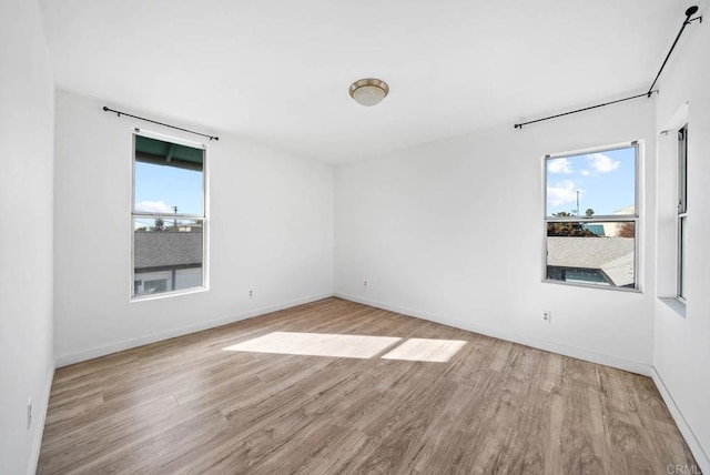 empty room featuring light hardwood / wood-style flooring and a wealth of natural light