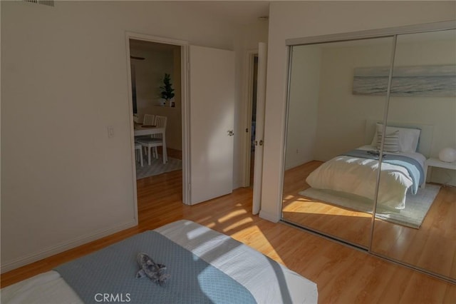 bedroom with a closet and wood-type flooring