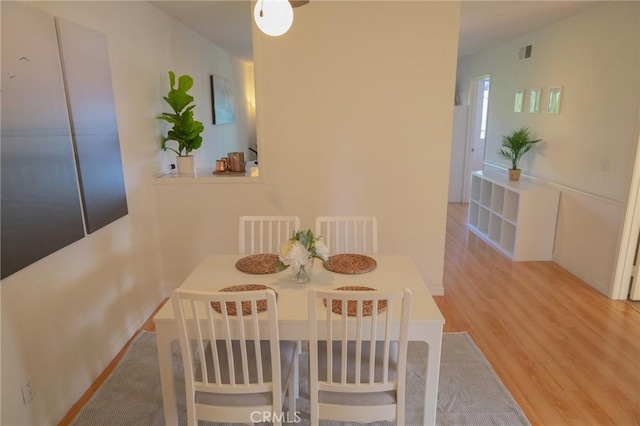 dining area with hardwood / wood-style floors