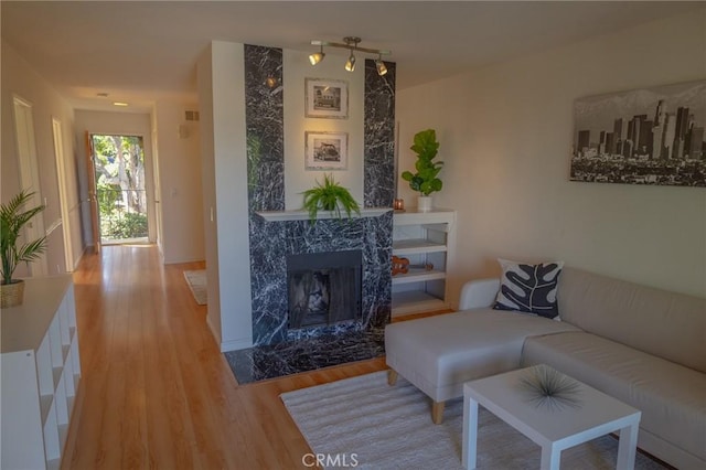 living room with hardwood / wood-style flooring and a fireplace