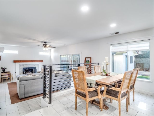 dining space with ceiling fan and light tile patterned flooring