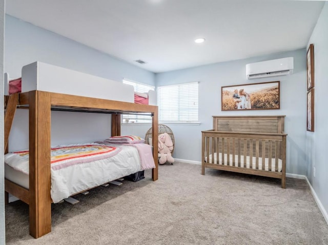 carpeted bedroom with a wall unit AC