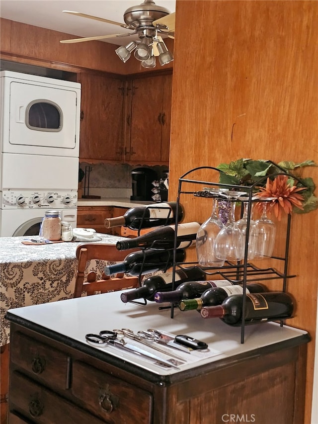 kitchen featuring ceiling fan and stacked washer and dryer