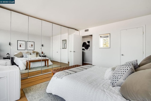 bedroom with a closet and light wood-type flooring