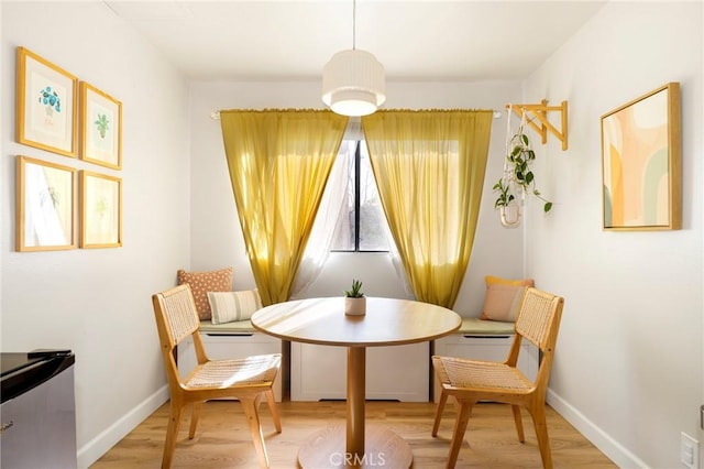 dining room featuring breakfast area and hardwood / wood-style flooring