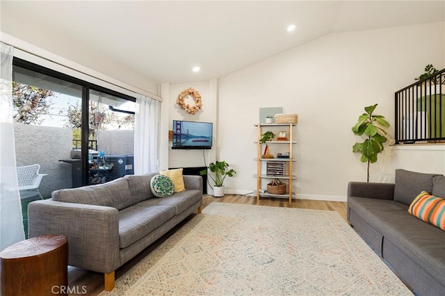 living room featuring light hardwood / wood-style flooring and vaulted ceiling