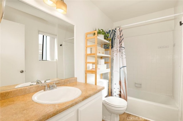 full bathroom with hardwood / wood-style floors, toilet, shower / tub combo, and vanity