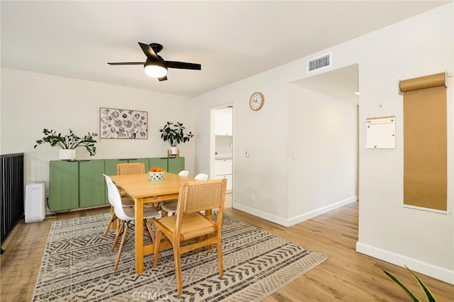 dining area with ceiling fan and light hardwood / wood-style flooring