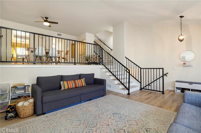 living room with ceiling fan and wood-type flooring