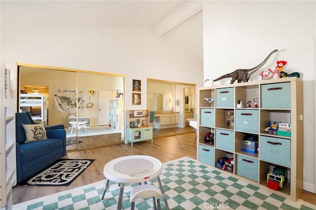 interior space with hardwood / wood-style flooring, beamed ceiling, and high vaulted ceiling