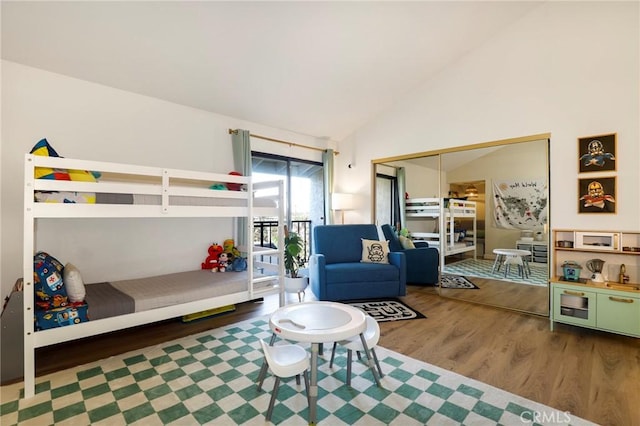 bedroom featuring hardwood / wood-style flooring, a closet, and lofted ceiling