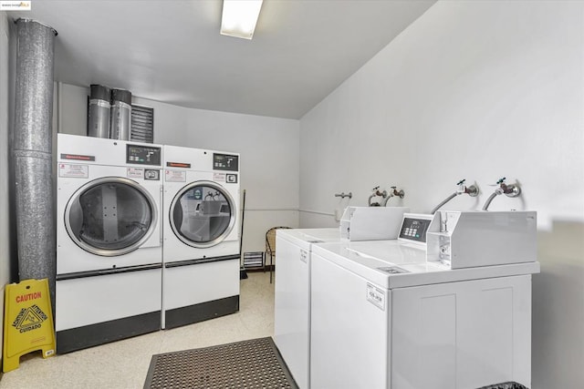 clothes washing area with washer and clothes dryer