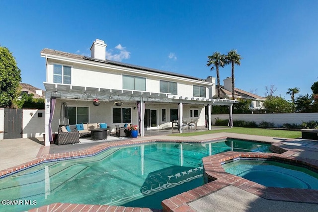 rear view of house featuring an outdoor living space, a swimming pool with hot tub, a pergola, and a patio